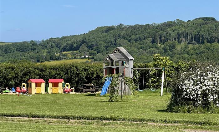 Children's play area with climbing tower, rock wall, slide and twin swing set. Also spring rocker and a range of other outdoor toys.